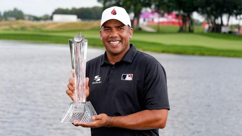 Jhonattan Vegas holds the trophy after winning the 3M Open...