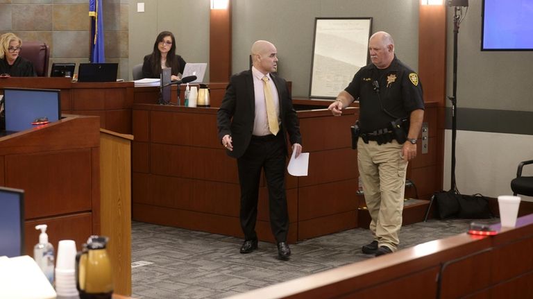 Robert Telles is directed off the witness stand after testifying...