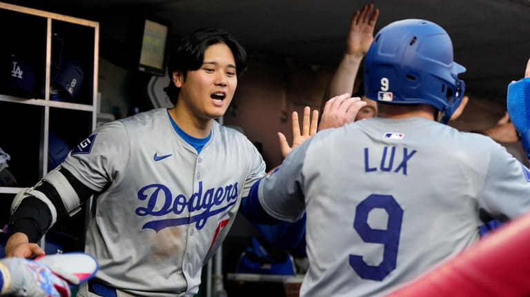 Los Angeles Dodgers' Gavin Lux (9) celebrates with Shohei Ohtani...