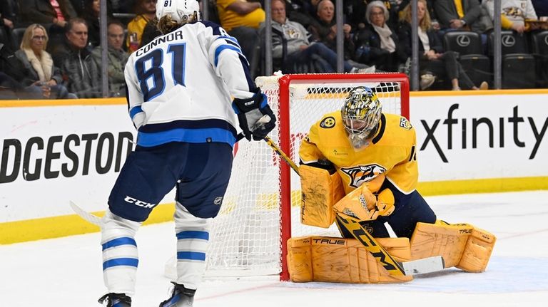 Nashville Predators goaltender Juuse Saros stops a shot by Winnipeg...