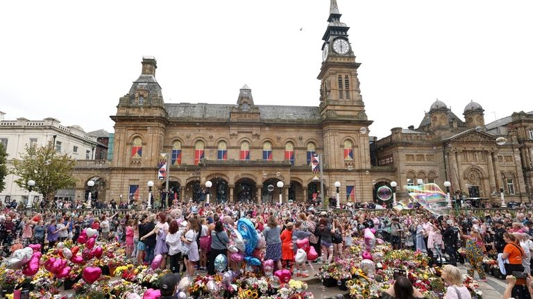 Members of the public form bubbles outside the Town Hall...