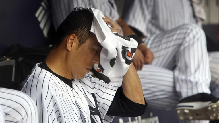 Hiroki Kuroda wipes sweat off his face during the second...