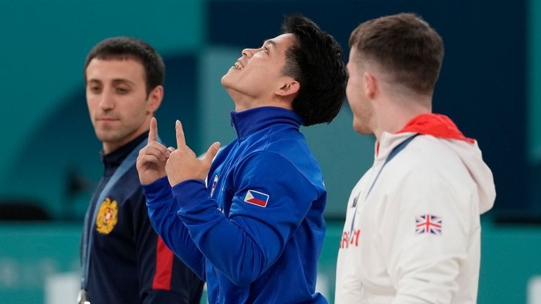 Silver medalist Artur Davtyan, left, of Armenia, stands in the...