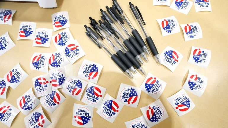 Pens are encircled by "I Voted" stickers at an election...