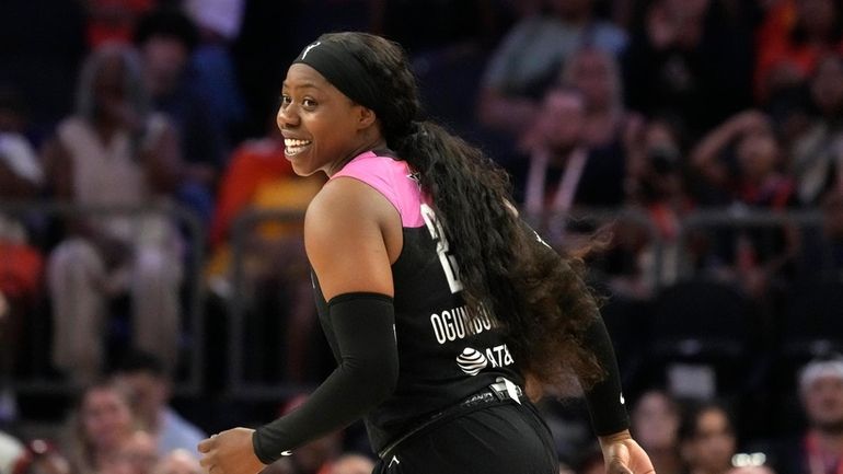 Arike Ogunbowale, of Team WNBA, smiles after hitting a 3-pointer...