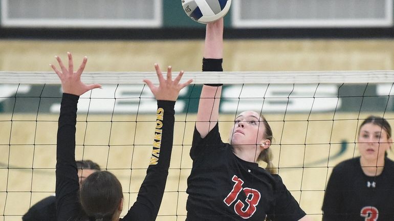 Keira McCaffrey #13 of Mineola looks to spike against Wantagh...