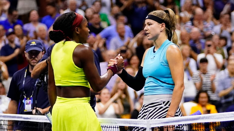 Coco Gauff, left, of the United States, shakes hands with...