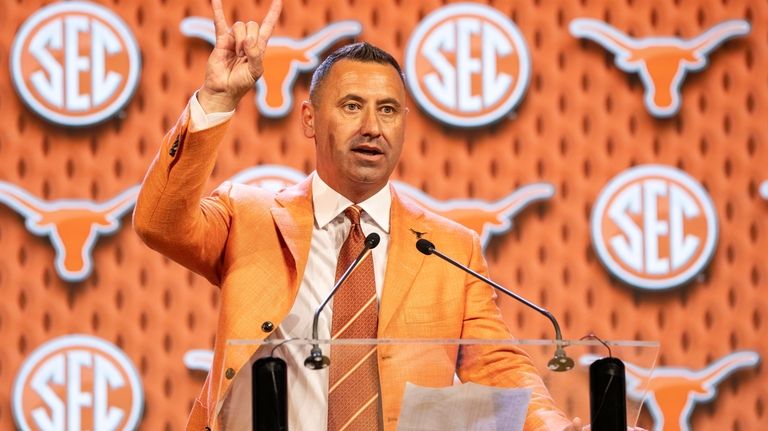 Texas head football coach Steve Sarkisian flashes the "Hook 'Em...