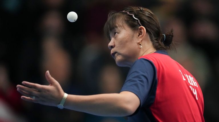 Chile's Zeng Zhigying serves the ball during a table tennis...