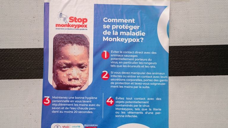 A poster bringing attention to the mpox outbreak hangs at...