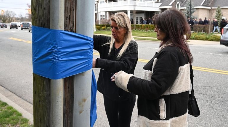 Liz Frank, left, and Stacy Nuzzi, both of Massapequa, put...