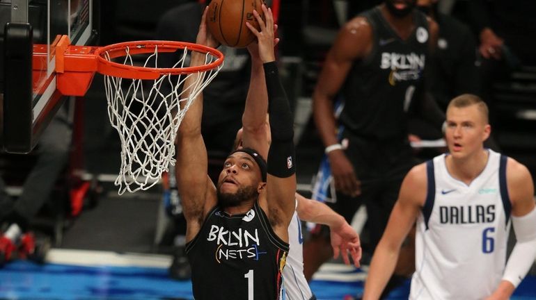 Nets guard Bruce Brown (1) is fouled by Dallas Mavericks...