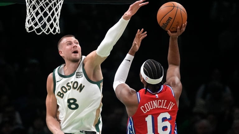 Boston Celtics center Kristaps Porzingis (8) tries to block a...
