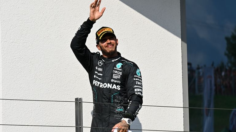 Mercedes driver Lewis Hamilton of Britain celebrates his third place...