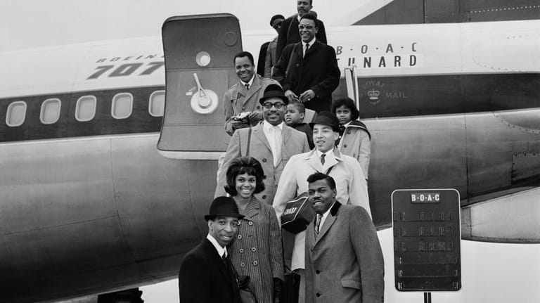 Smokey Robinson, front, and his band The Miracles, who include...
