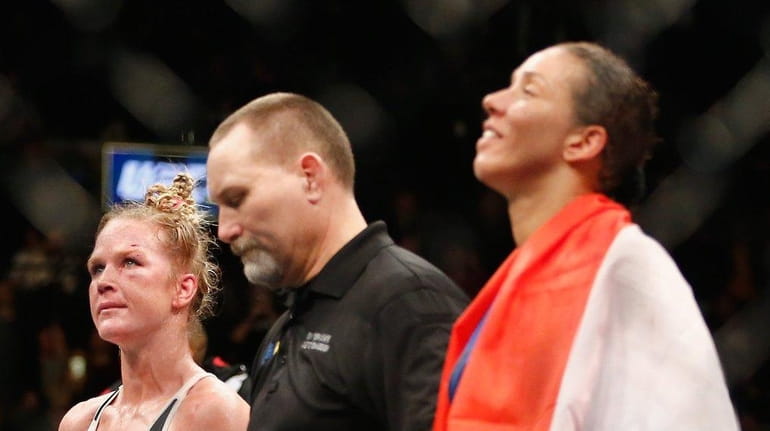 Holly Holm and Germaine de Randamie, with referee Todd Anderson...