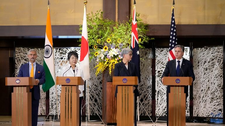 U.S. Secretary of State Antony Blinken, right, speaks during a...