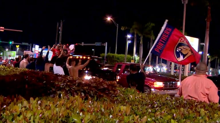 In this image made from video provided by WSVN-TV, people...