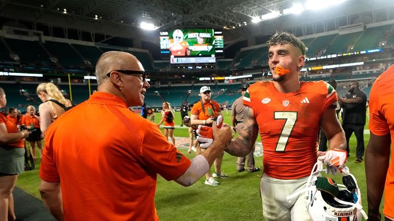 Miami Hurricanes wide receiver Xavier Restrepo (7) shakes hands as...