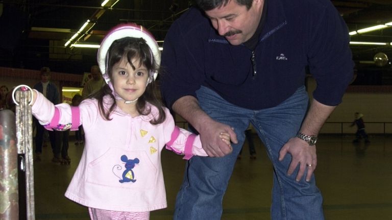 Michael Meier, of East Islip, skates with his daughter Aileen,...