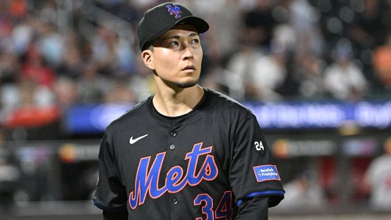 Mets starting pitcher Kodai Senga walks to the dugout after...