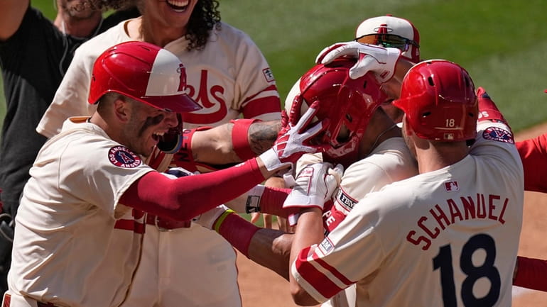 Los Angeles Angels' Logan O'Hoppe, second from right, is swarmed...