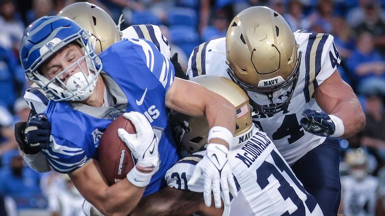 Memphis receiver Koby Drake (10) gets brought down by Navy...