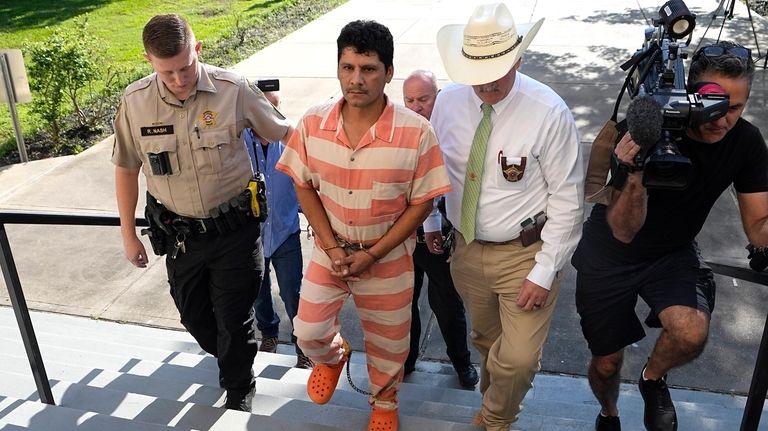 Francisco Oropeza, center, is escorted to the San Jacinto County...