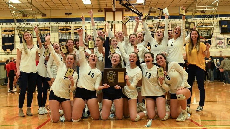 The Massapequa girls volleyball team celebrates after winning the Nassau...