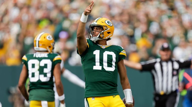 Green Bay Packers quarterback Jordan Love (10) reacts after carrying...