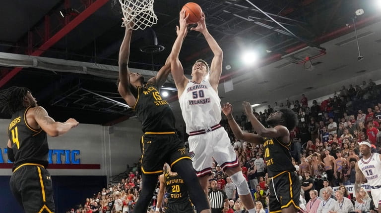 Florida Atlantic center Vladislav Goldin (50) drives to the basket...