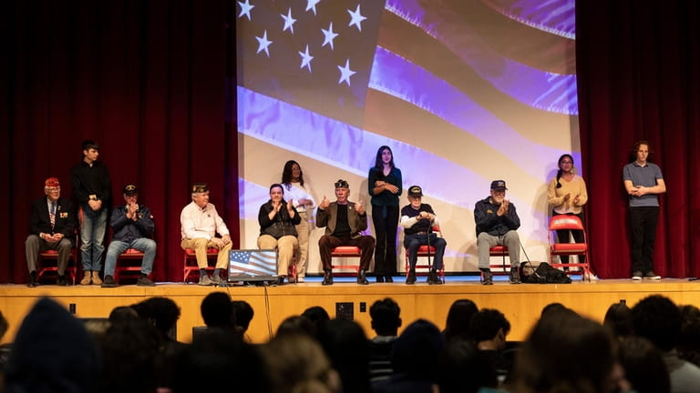 Military veterans and Glen Cove High School students Wednesday.