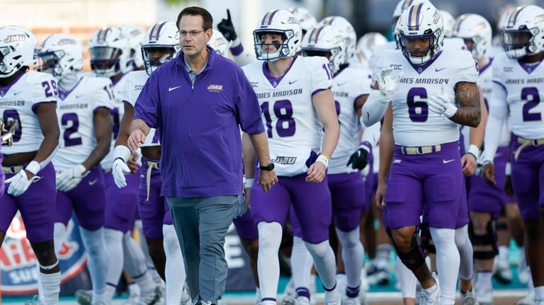 James Madison head coach Curt Cignetti leads his team onto...