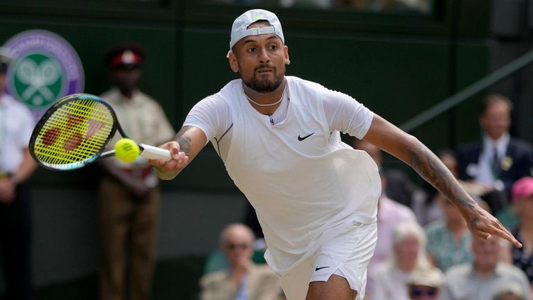 Australia's Nick Kyrgios returns to Serbia's Novak Djokovic in the...