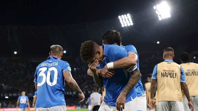 Napoli's Giovanni Di Lorenzo, center, celebrates after scoring a goal...