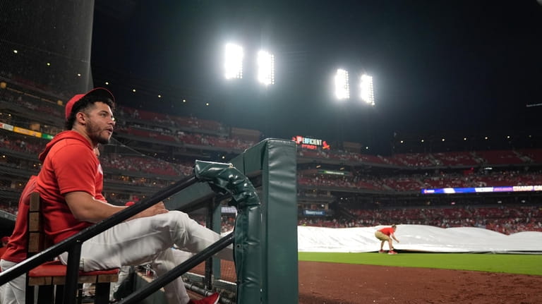 St. Louis Cardinals' Willson Contreras sits in the dugout as...