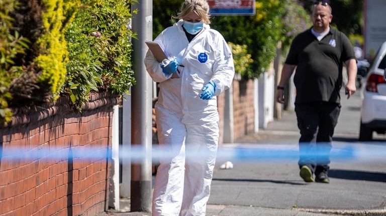 A police scenes of crime officer (SOCO) works at the...