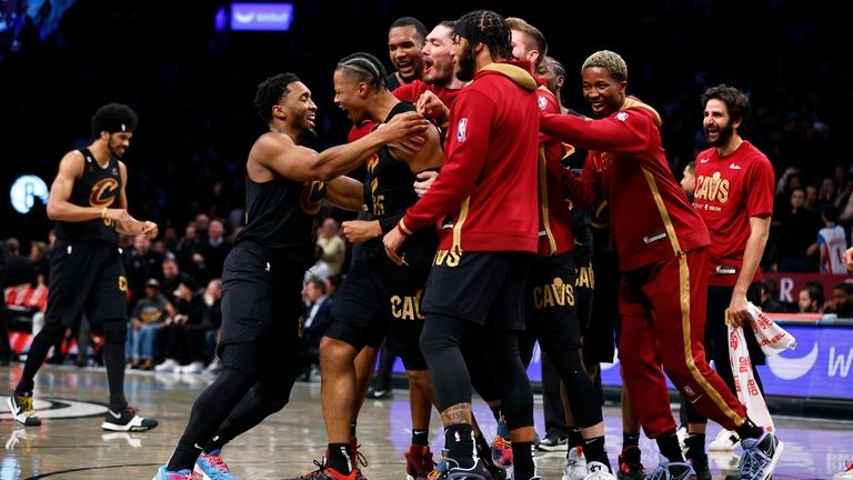 Cleveland Cavaliers guard Donovan Mitchell, front left, congratulates forward Isaac...