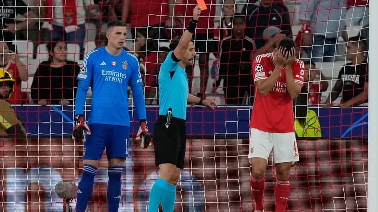 Turkish referee Halil Umut Meler shows a red card to...