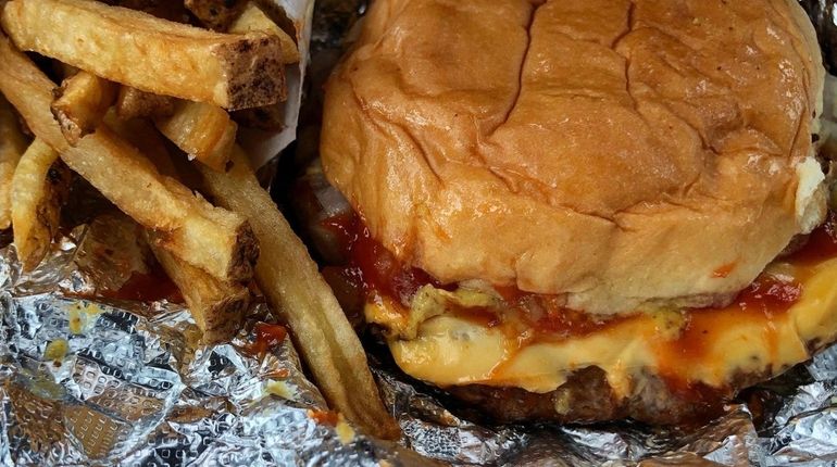 A classic griddled cheeseburger and French fries from Boxcar Burgers,...