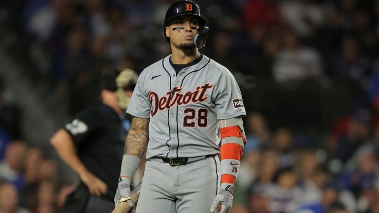 Detroit Tigers' Javier Báez walks back to the dugout after...