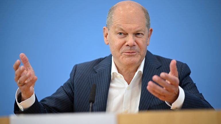 German Chancellor Olaf Scholz addresses the media during his summer...