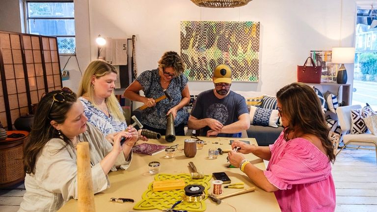 Meghan Angliss, Jennifer DeSane, Joe Berlangero and Noelle Fiallo-Evans make bracelets...