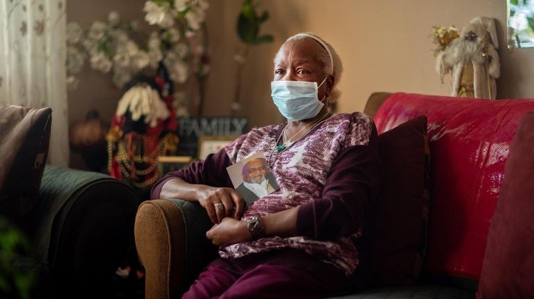 Rosa Marion, of Central Islip, holds a picture of her...