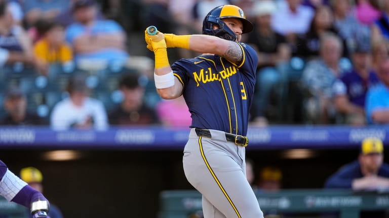Milwaukee Brewers' Jake Bauers follows the flight of his RBI...