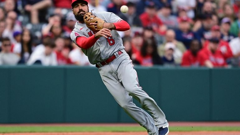 Los Angeles Angels third baseman Anthony Rendon throws to first...