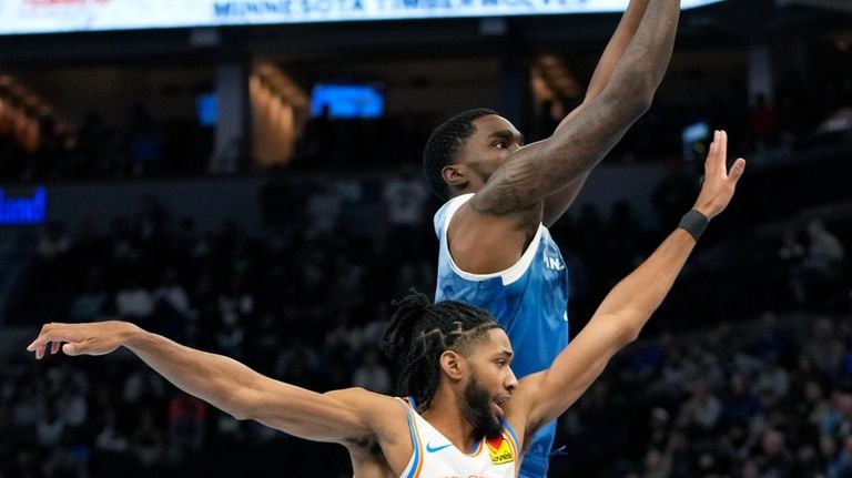 Minnesota Timberwolves guard Shake Milton goes up for a shot...