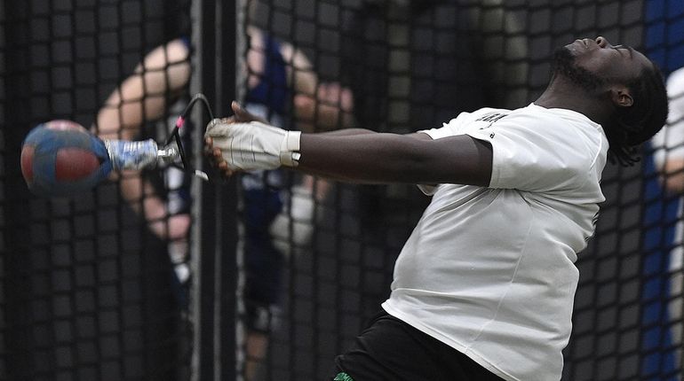 Jahvirye Wilks of Farmingdale makes a toss of 60 feet,...