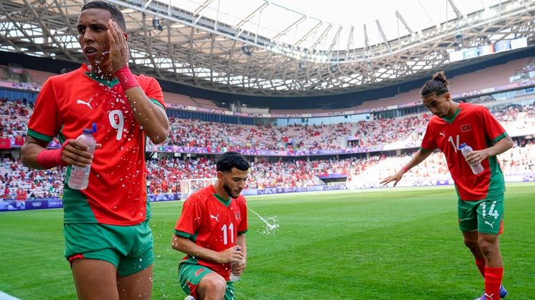 Morocco's Soufiane Rahimi, left, Zakaria El Ouahdi, center, and Oussama...