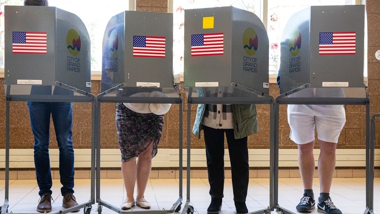 Voters cast their ballots at Coit Arts Academy in Grand...